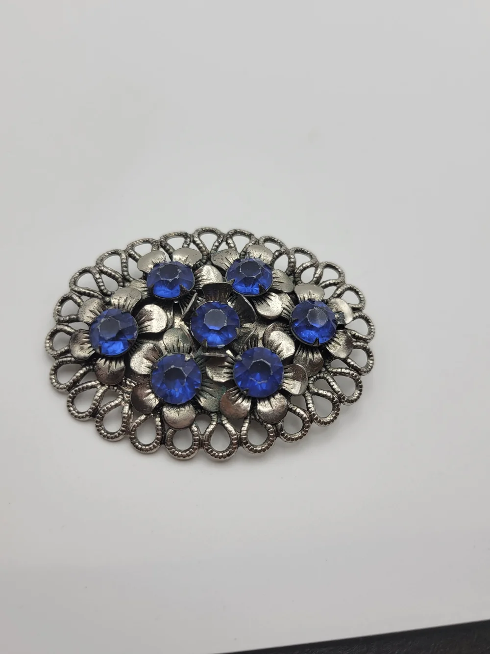 Vintage-Inspired Silver Floral Brooch with Blue Crystal Accents